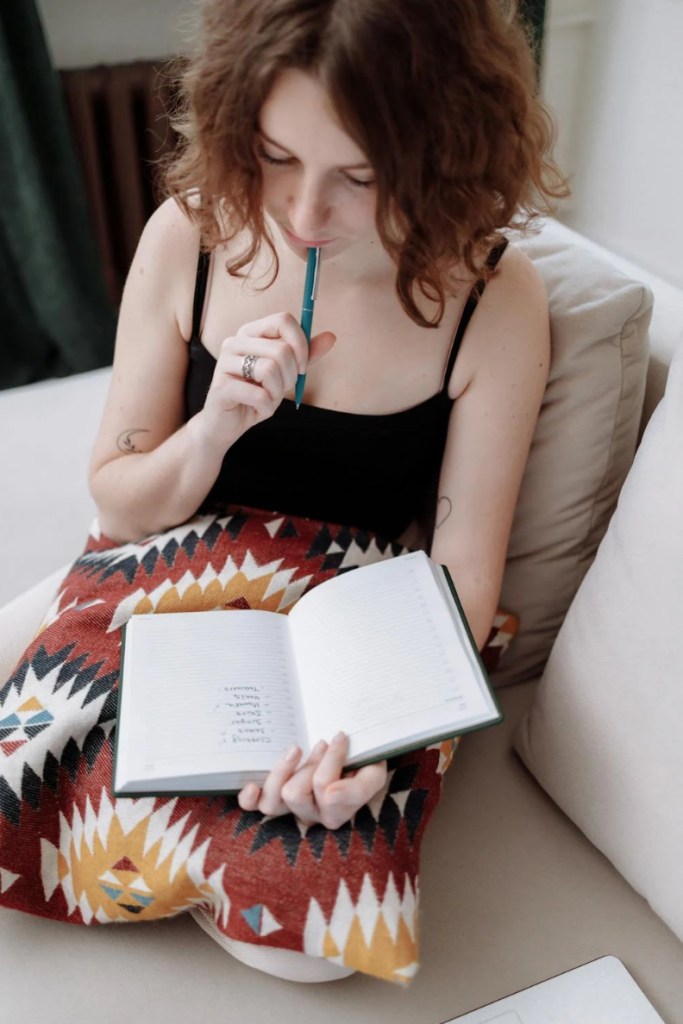 Woman journaling for self-growth and productivity